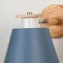 Closeup view of wooden wall sconce with blue conical lampshade stylish modern indoor wall light for kids room and bedroom lighting decor
