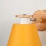 Closeup view of wooden wall sconce with yellow conical lampshade stylish modern indoor wall light for kids room bedroom and study lighting decor.