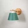 Modern wooden wall sconce with green lampshade light off white background for bedroom study room and hallway stylish decorative wall lighting.
