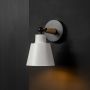 Elegant wall light glowing with matte white shade wooden handle and black base ideal for ambient modern interior lighting.