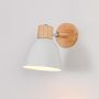 Wood and white wall light glowing gently on a neutral wall highlighting Scandinavian-inspired simple design.