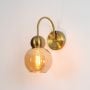 larkson wall light gold amber light on white background