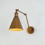 Vintage brass wall lamp with adjustable cone metal shade perfect for modern bedroom study or living room lighting.