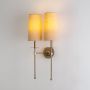 longarm style double wall light in gold beige shades light on white background