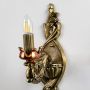 Close detailed view of antique gold wall sconce showing ornate carved patterns and candle style bulb holder ideal for classic decorative interiors.