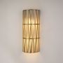 Vertical cylindrical gold wall light with rod frame and glass body clearly displayed on clean white background wall