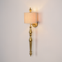 Lamp styled wall light  on white background showing tall gold metal body with soft fabric shade for clean modern product presentation.