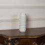 Glossy ribbed ceramic vase in white finish displayed against plain white background for clean product view.