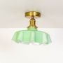 Fluted green glass ceiling light with gold metal fixture elegant design for kitchens hallways or living rooms.