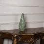 Green sculpted vase placed on a clean white background showcasing its fluid handcrafted look and unique artistic curves that add a stylish modern touch to home decor.
