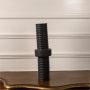 Modern black metal candle holder with ribbed cylindrical design displayed on white background ideal for table decor styling.