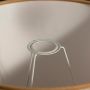 A closeup view showing the inside ring holder of a fabric lampshade with soft beige texture highlighted under gentle light creating a detailed interior look.