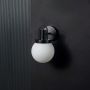 Matte White Glass Globe Wall Sconce Light Off Black Background